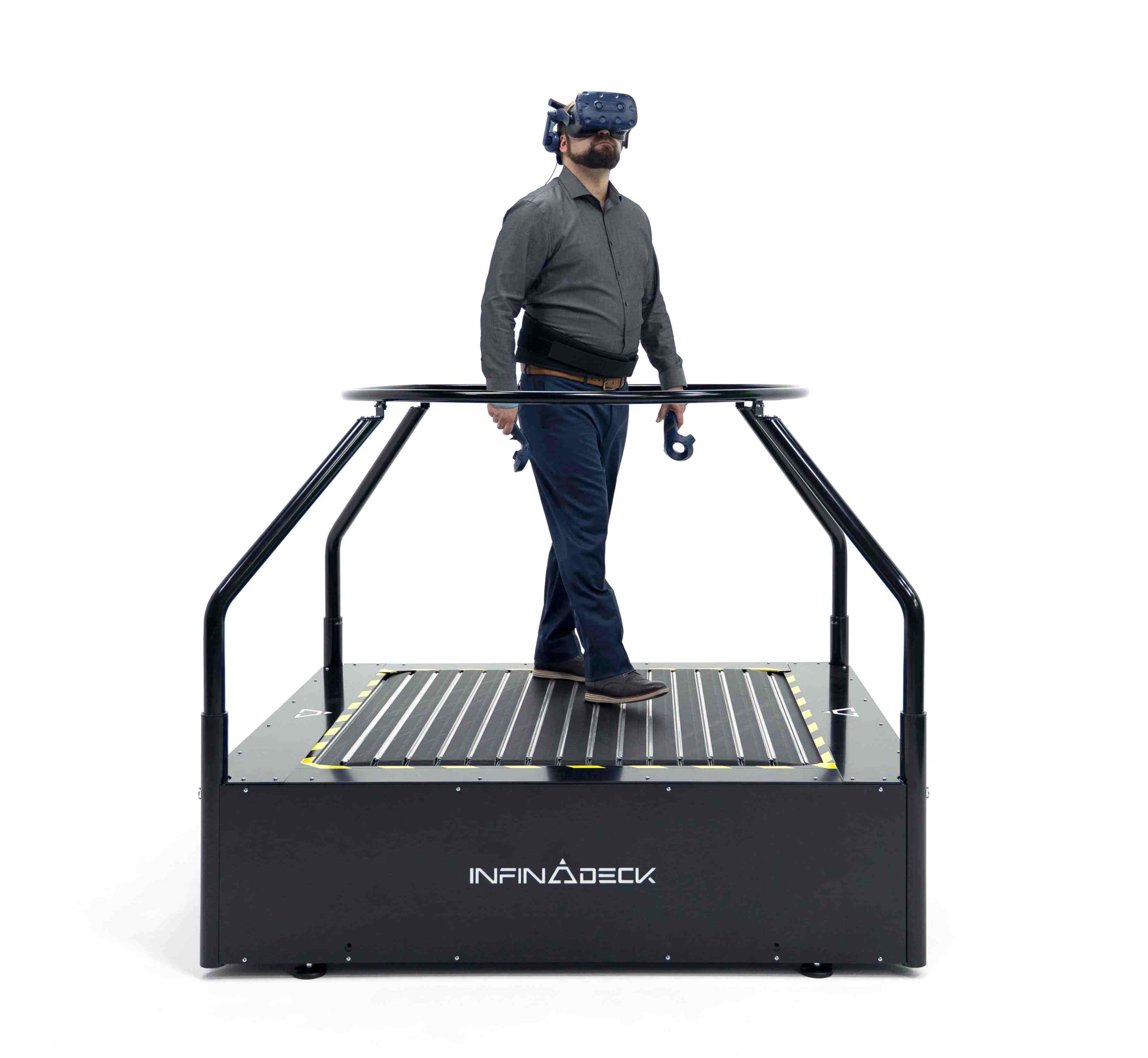 Man walking on an Infinadeck with a VR headset on